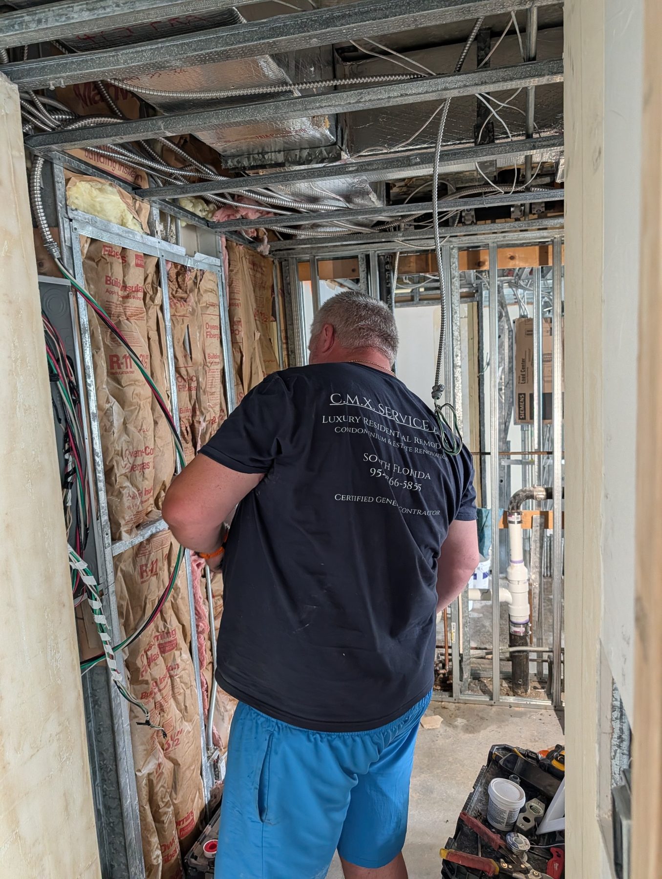 Condominium remodeling work in progress with ceiling framing and ocean view